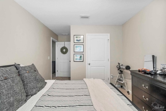 bedroom featuring carpet floors, visible vents, and baseboards