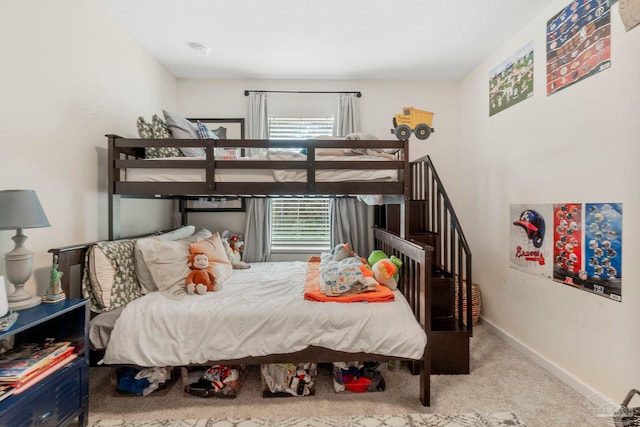 carpeted bedroom with baseboards