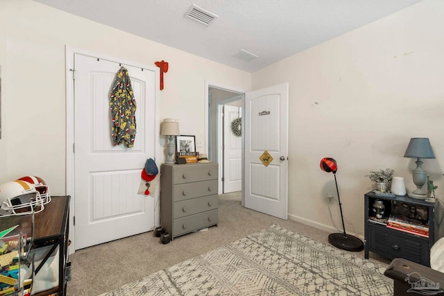 carpeted bedroom featuring baseboards and visible vents