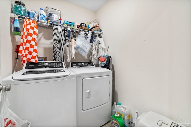 clothes washing area featuring laundry area and washer and clothes dryer