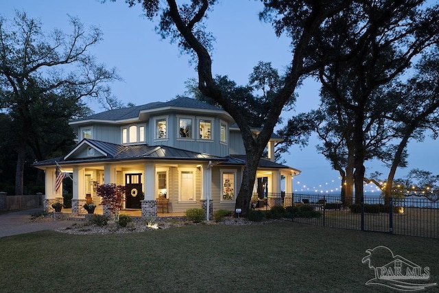 2 Bayou Blvd, Pensacola, FL 32503 - back of property with fence, a standing seam roof, covered porch, a lawn, and metal roof