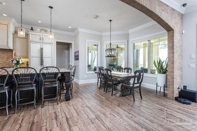 2 Bayou Blvd, Pensacola, FL 32503 - dining space with crown molding, recessed lighting, baseboards, wood finished floors, and visible vents