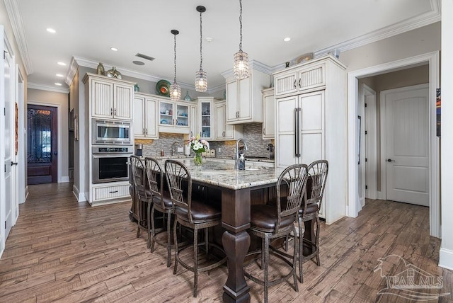 2 Bayou Blvd, Pensacola, FL 32503 - kitchen with decorative backsplash, dark wood-style flooring, appliances with stainless steel finishes, and a breakfast bar
