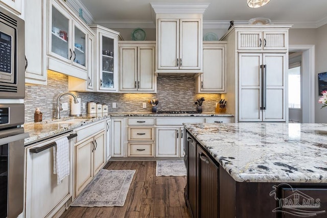 2 Bayou Blvd, Pensacola, FL 32503 - kitchen with dark wood-style flooring, light stone countertops, a sink, stainless steel appliances, and decorative backsplash