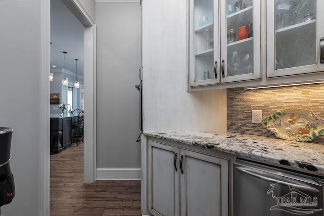 2 Bayou Blvd, Pensacola, FL 32503 - bar with tasteful backsplash, stainless steel dishwasher, baseboards, ornamental molding, and dark wood-type flooring