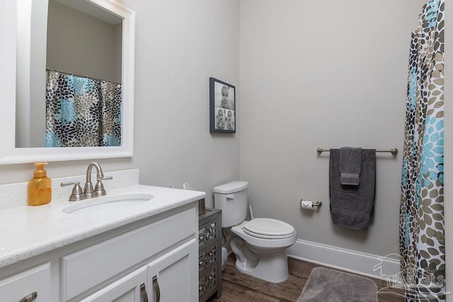 2 Bayou Blvd, Pensacola, FL 32503 - bathroom with a shower with shower curtain, toilet, wood finished floors, and vanity