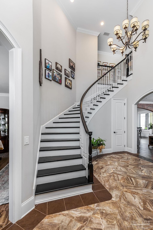 2 Bayou Blvd, Pensacola, FL 32503 - stairs featuring visible vents, ornamental molding, marble finish floor, a towering ceiling, and baseboards