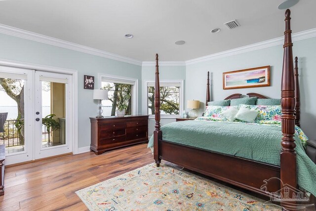 2 Bayou Blvd, Pensacola, FL 32503 - bedroom with crown molding, visible vents, wood finished floors, access to outside, and french doors