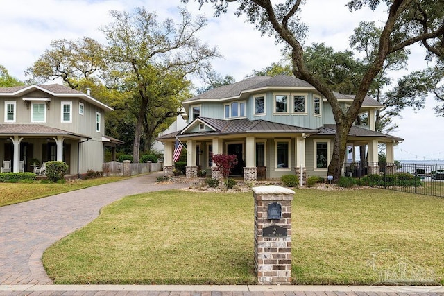 2 Bayou Blvd, Pensacola, FL 32503 - view of front of home featuring a porch, a standing seam roof, metal roof, decorative driveway, and fence