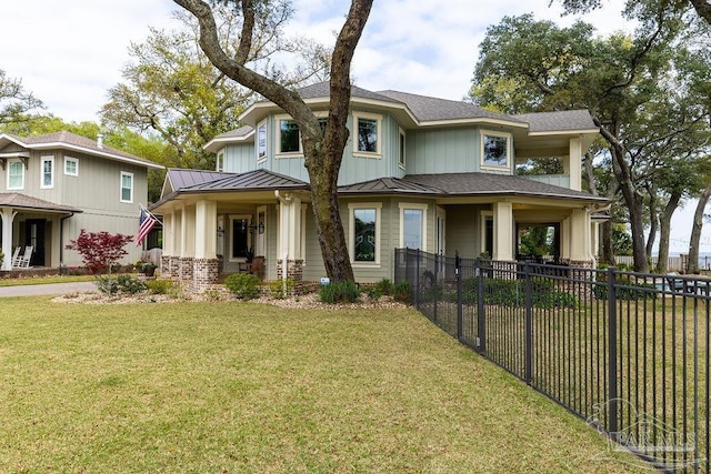 2 Bayou Blvd, Pensacola, FL 32503 - view of front of property featuring a standing seam roof, metal roof, a front yard, fence, and a shingled roof