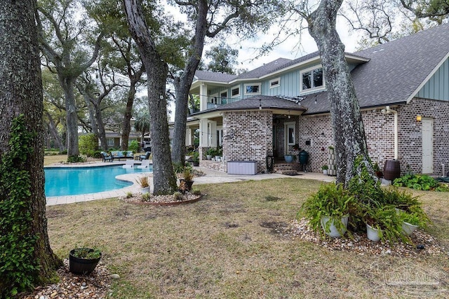 2 Bayou Blvd, Pensacola, FL 32503 - rear view of house with brick siding, board and batten siding, roof with shingles, and a patio area