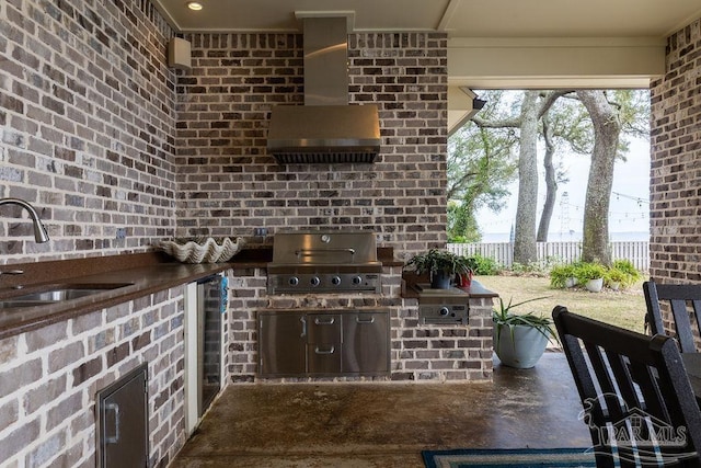 2 Bayou Blvd, Pensacola, FL 32503 - kitchen featuring brick wall, a sink, and wall chimney exhaust hood