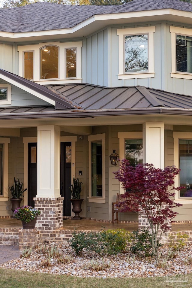 2 Bayou Blvd, Pensacola, FL 32503 - doorway to property featuring board and batten siding, covered porch, a standing seam roof, metal roof, and roof with shingles