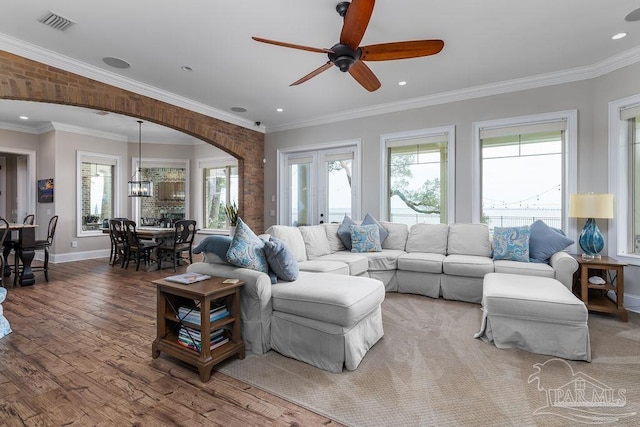 2 Bayou Blvd, Pensacola, FL 32503 - living room featuring visible vents, wood finished floors, baseboards, arched walkways, and ceiling fan with notable chandelier