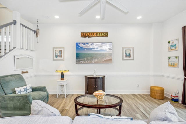 living room with light wood-type flooring and ceiling fan