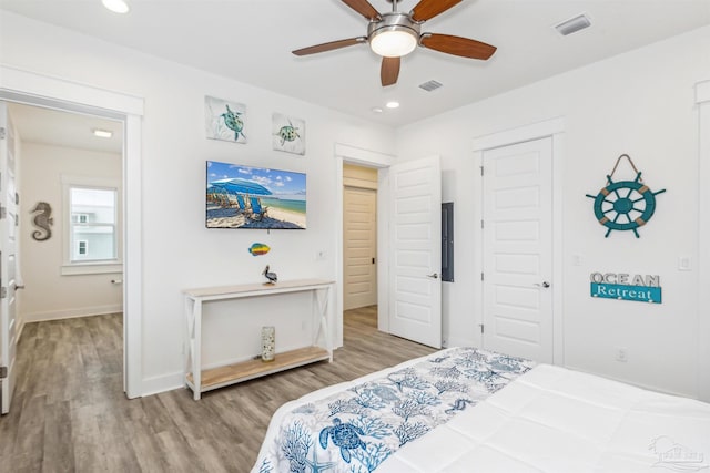 7395 Grand Navarre Blvd, Navarre Beach, FL 32566 - bedroom with wood finished floors, a closet, recessed lighting, baseboards, and a ceiling fan