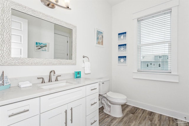 bathroom with vanity, toilet, and wood-type flooring