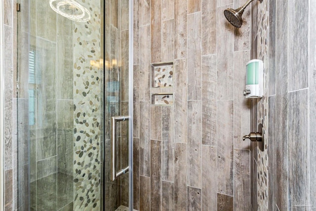 bathroom featuring a shower with shower door