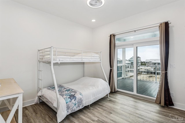 bedroom with access to exterior and wood-type flooring