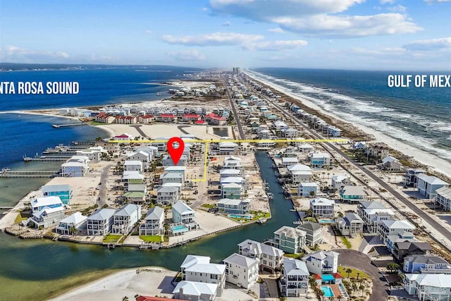 drone / aerial view featuring a water view and a view of the beach