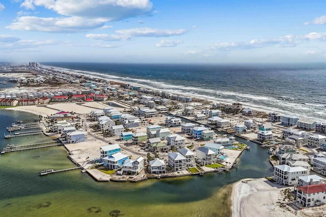 birds eye view of property with a water view and a view of the beach