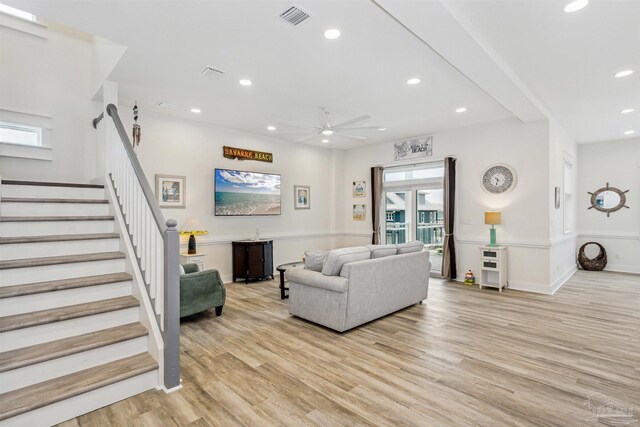 living room featuring light wood-type flooring and ceiling fan