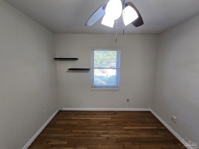 spare room featuring dark hardwood / wood-style floors and ceiling fan