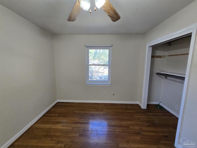 unfurnished bedroom with dark wood-type flooring, a closet, and ceiling fan