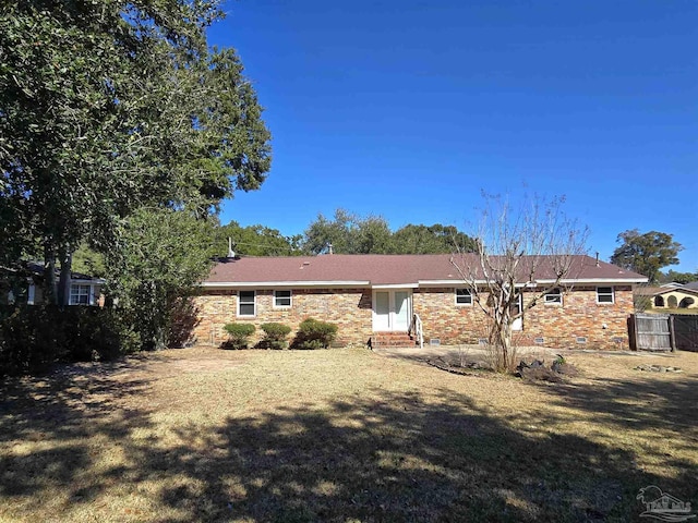 back of property with a lawn