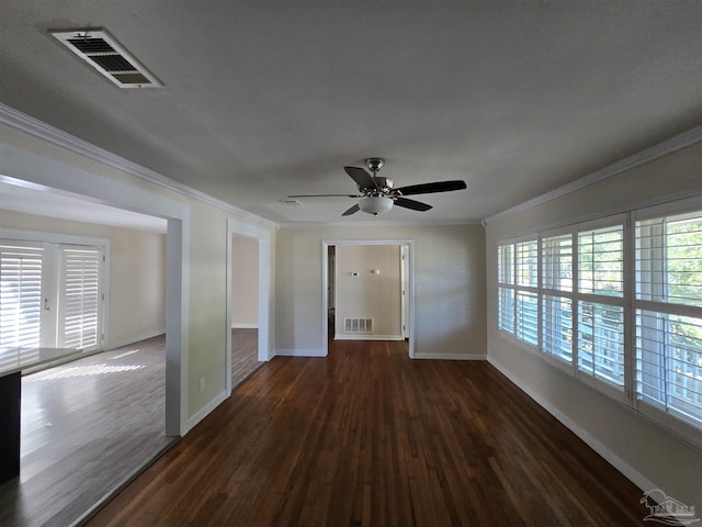 empty room featuring ornamental molding, dark hardwood / wood-style floors, and ceiling fan