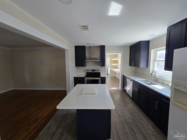 kitchen with a kitchen island, sink, dark hardwood / wood-style flooring, stainless steel appliances, and wall chimney exhaust hood