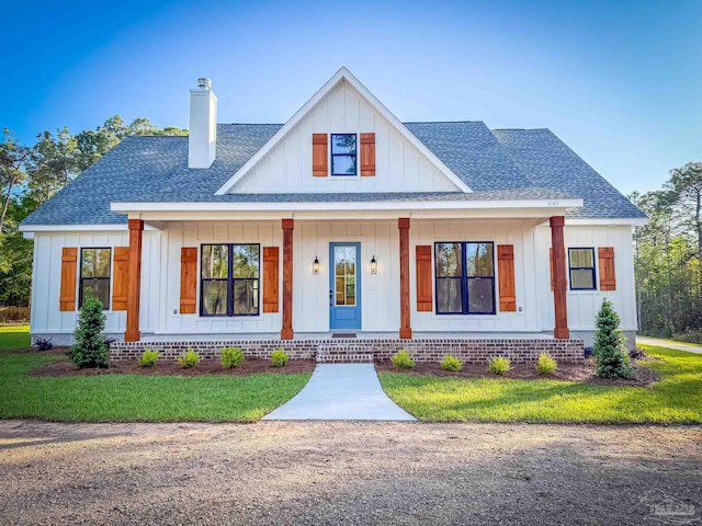 6145 Mary Kitchens Rd, Milton, FL 32583 - modern farmhouse with a porch, board and batten siding, a shingled roof, and a chimney
