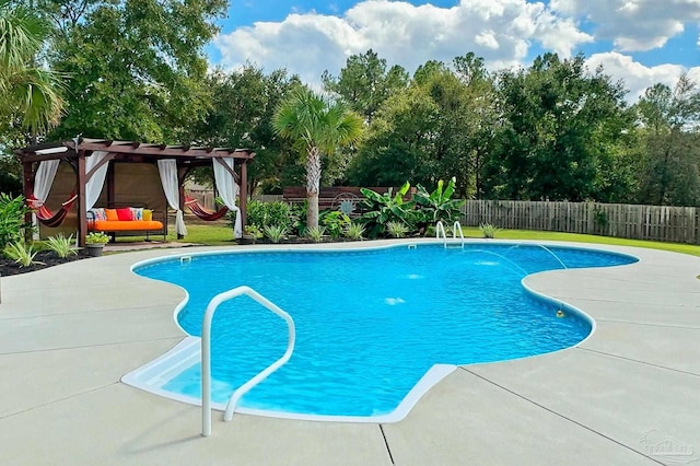 view of swimming pool featuring pool water feature, a patio area, and a pergola