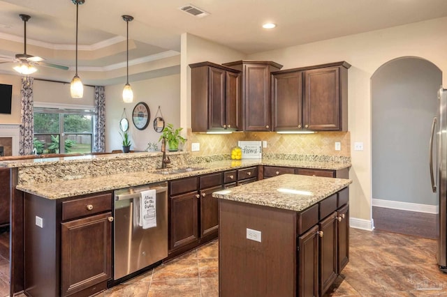 kitchen featuring appliances with stainless steel finishes, sink, a center island, kitchen peninsula, and dark brown cabinetry