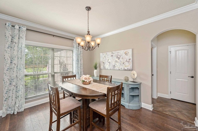 dining space with ornamental molding, dark wood-type flooring, and a textured ceiling