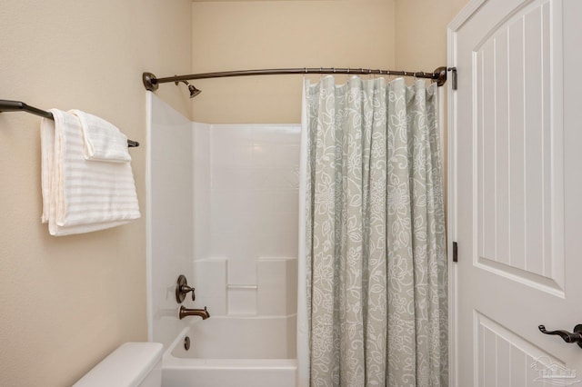 bathroom with toilet and shower / bath combo