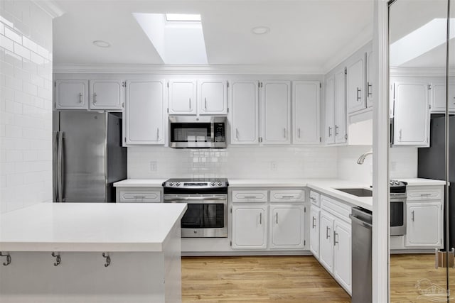 3108 Station Ct, Pensacola, FL 32504 - kitchen featuring stainless steel appliances, backsplash, light countertops, crown molding, and recessed lighting
