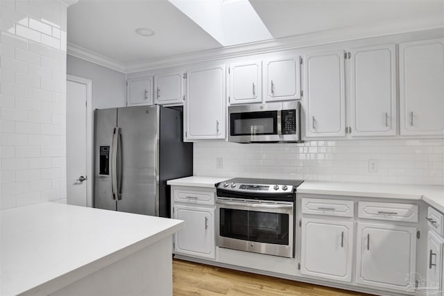3108 Station Ct, Pensacola, FL 32504 - kitchen with appliances with stainless steel finishes, ornamental molding, light countertops, and white cabinets