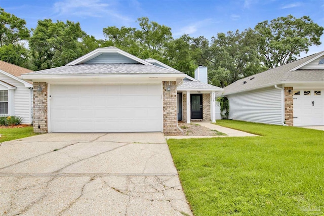 3108 Station Ct, Pensacola, FL 32504 - single story home featuring a front yard, driveway, a chimney, a shingled roof, and an attached garage