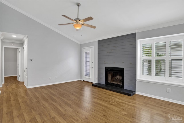 3108 Station Ct, Pensacola, FL 32504 - unfurnished living room featuring wood finished floors, ceiling fan, a large fireplace, ornamental molding, and vaulted ceiling