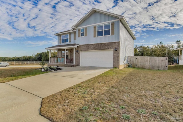 craftsman-style house featuring a front yard, covered porch, and a garage