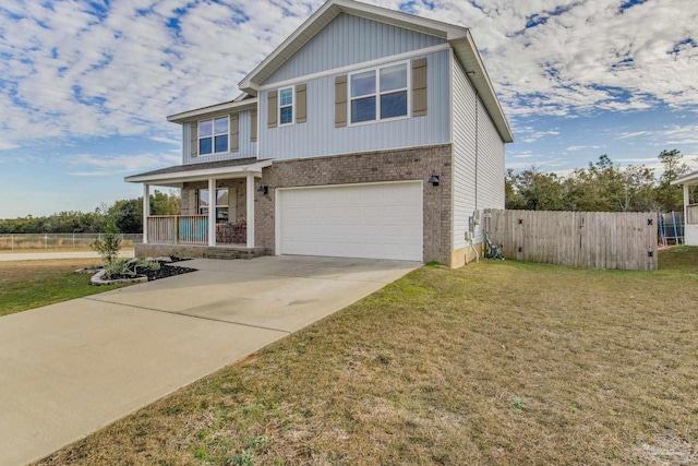 craftsman house featuring a garage, a front yard, and covered porch