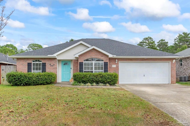 ranch-style home with a front yard, central AC unit, and a garage