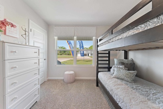 carpeted bedroom featuring baseboards