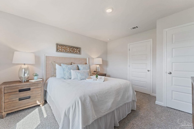 carpeted bedroom featuring baseboards and visible vents