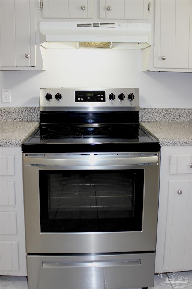 kitchen featuring white cabinetry and stainless steel range with electric stovetop