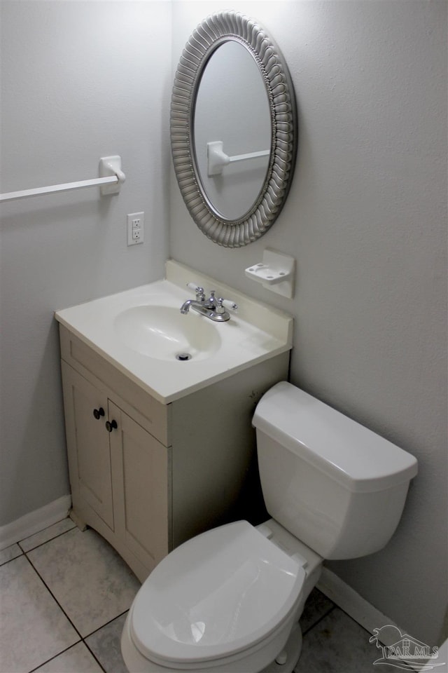 bathroom featuring vanity, toilet, and tile patterned flooring