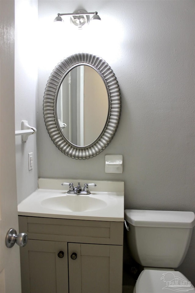 bathroom featuring vanity and toilet