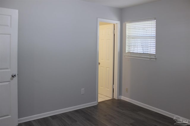 empty room featuring dark wood-type flooring