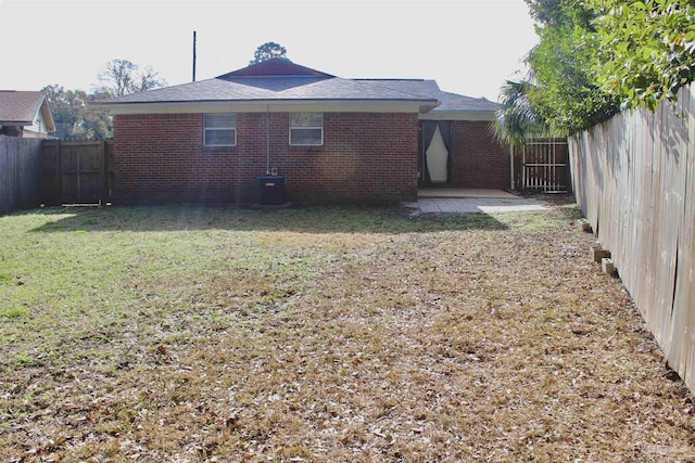 back of property featuring a yard, central AC, and a patio area